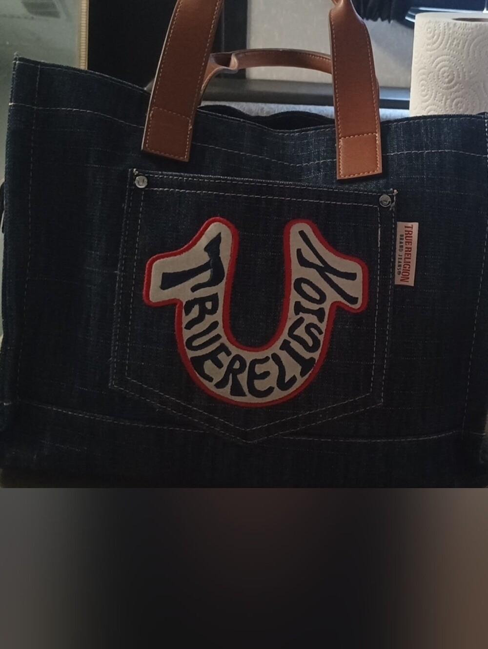 True Religion Dark Denim Tote with Brown Leather Handles and Red Trim Logo